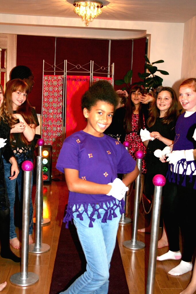 Girl posing for a picture in the t-shirt she made on a catwalk.