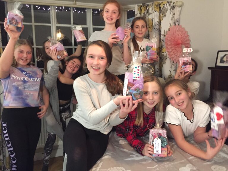 Bath bomb making party with girls holding up their spa products