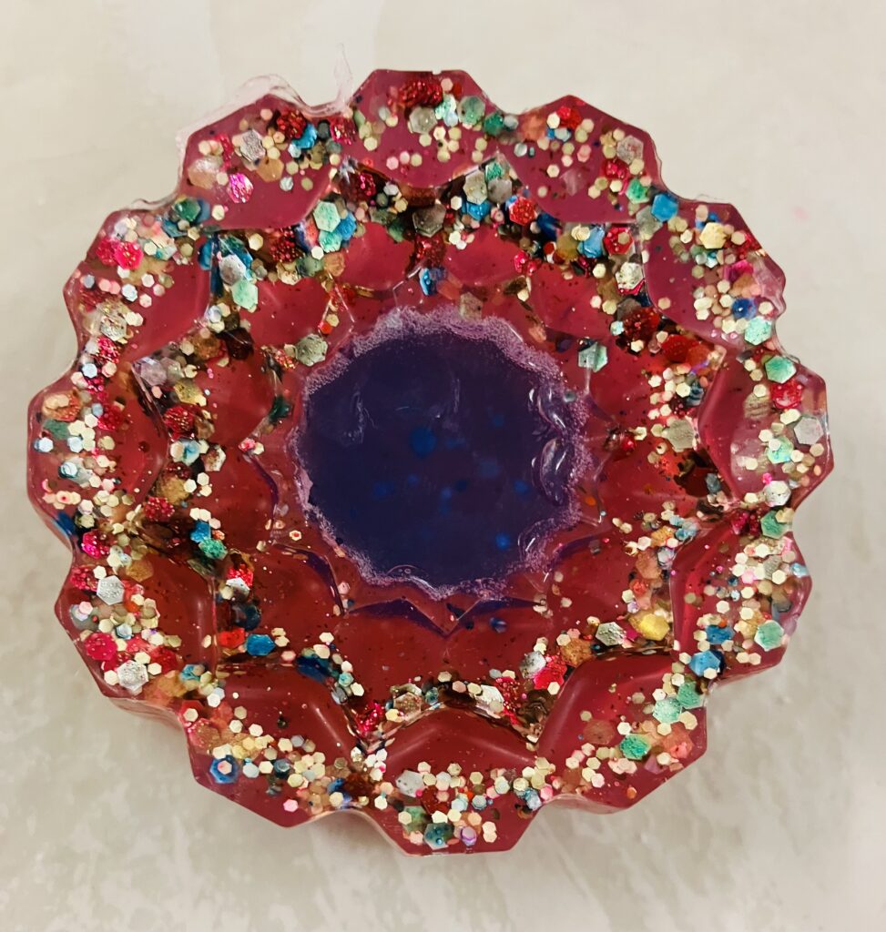 Red glittery flower shaped soap with a blue center