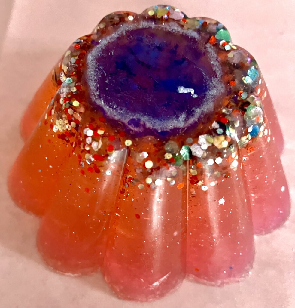 Orange glittery soap with a blue circular center