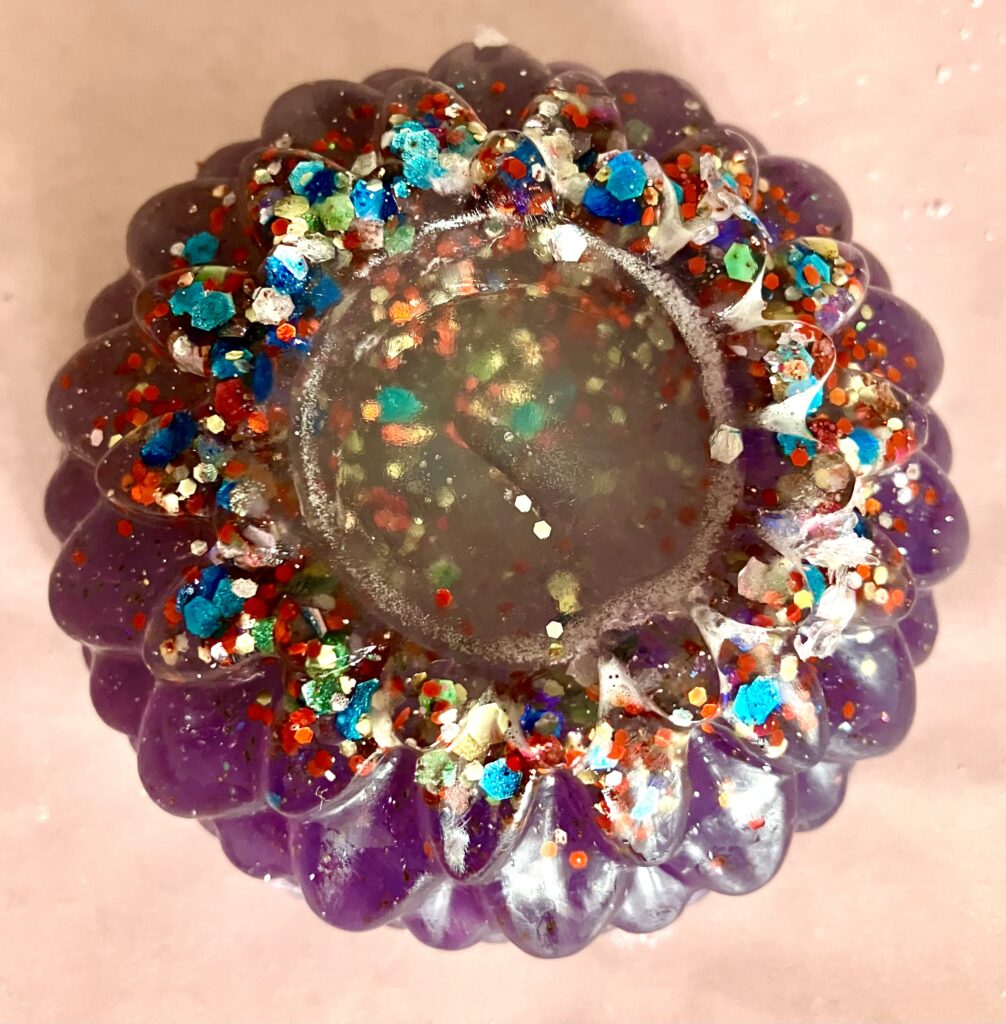 Pink flower shaped soap decorated with bio-glitter with transparent center