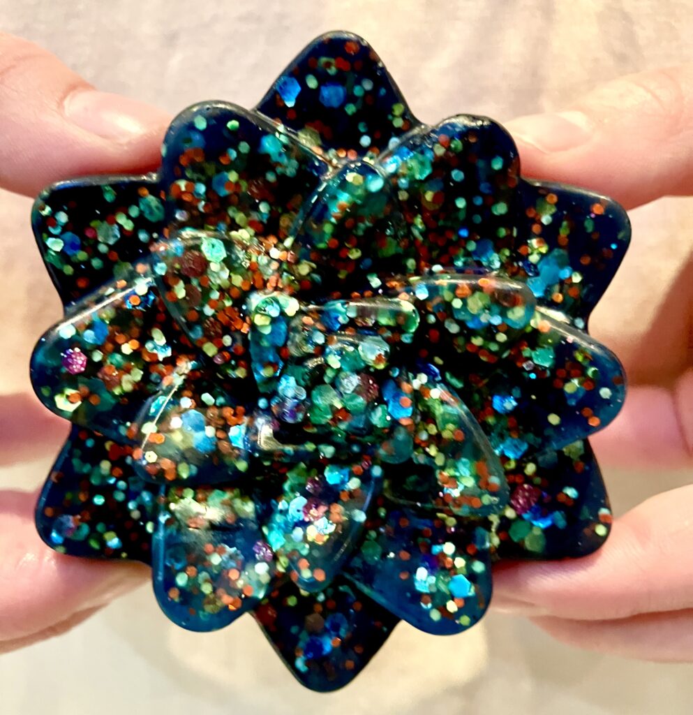 Dark blue glittery flower shaped soap