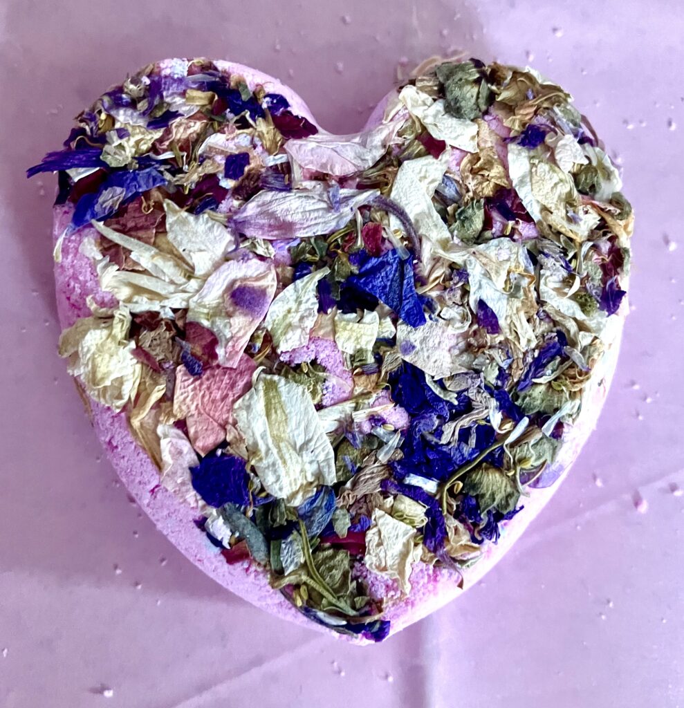 Lilac coloured heart shaped -with assorted dried blue, white and pink flowers.