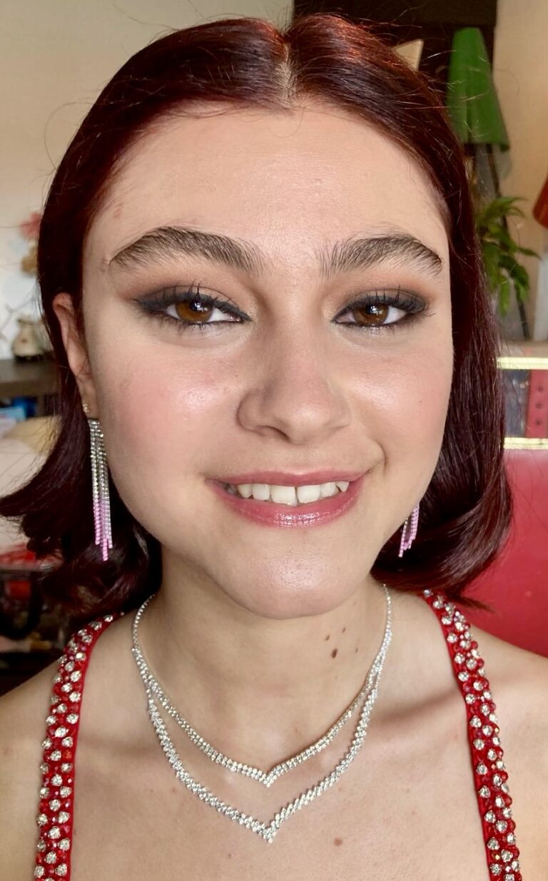 Beautiful girl smiling for a picture, hair and make up complete ready for the prom.