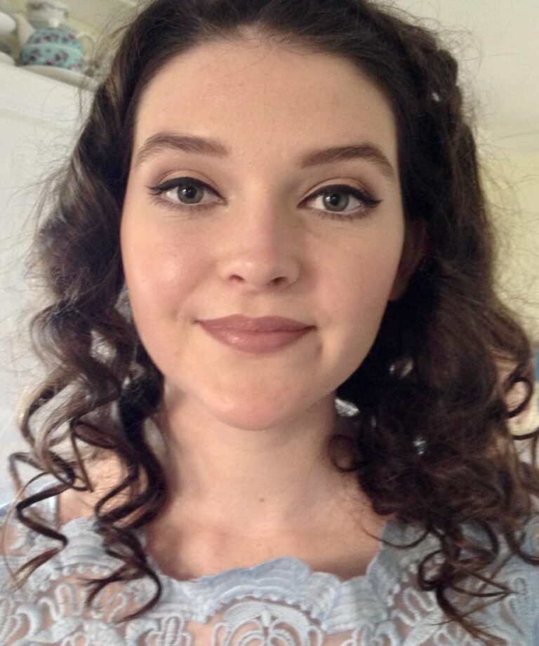 portrait image of a girl posing showing off her prom hair and make up.