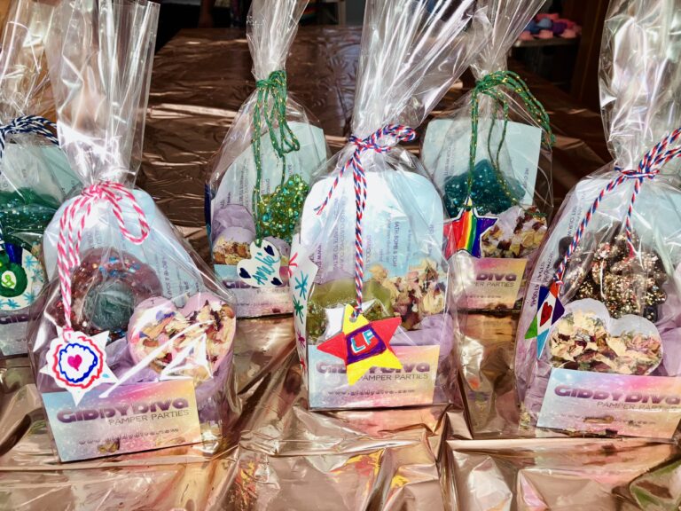 Decorated party bags containing bath-bombs and soaps.