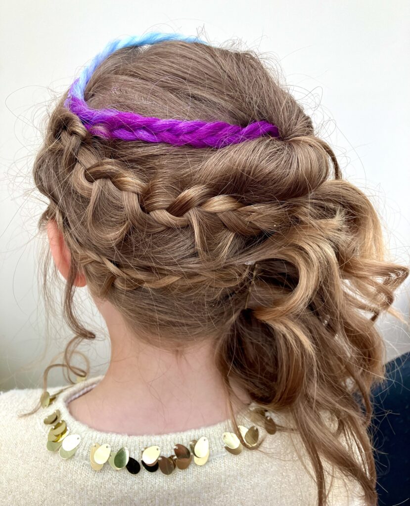 Two braids sweeping around the back of the head with a coloured hair extention.